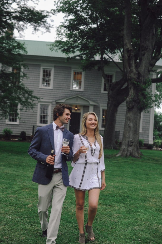 Couple dressed up walking and drinking white wine