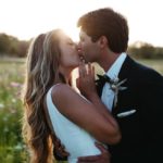 bride and groom kissing in the vineyard at Windmill Creek
