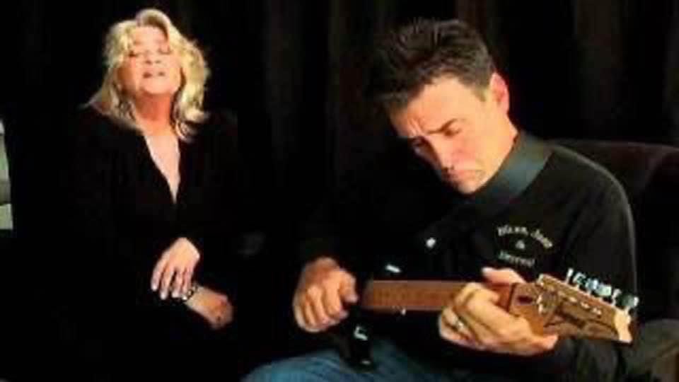 Man playing guitar and woman singing