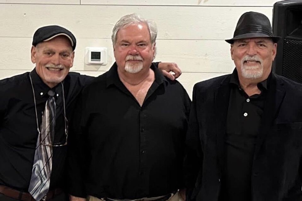 three older men in black shirts
